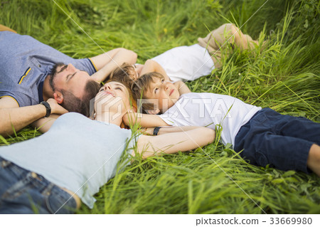 Happy family in the meadow 33669980