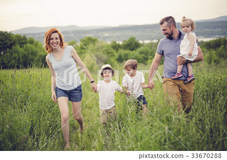 Happy family in the meadow 33670288