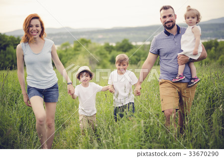 Happy family in the meadow 33670290