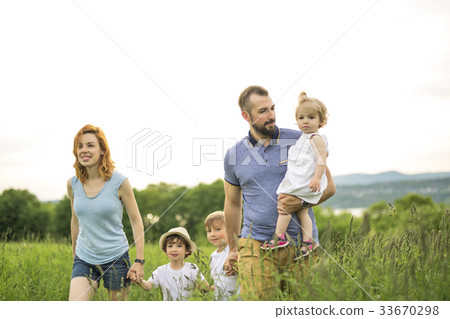 Happy family in the meadow 33670298
