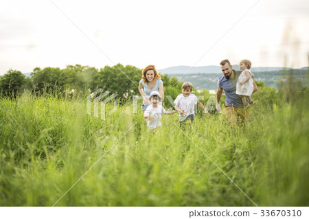 Happy family in the meadow 33670310
