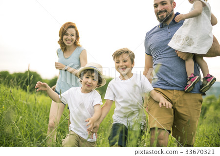 Happy family in the meadow 33670321