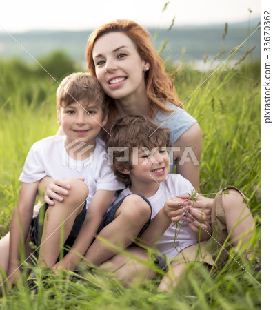Cute kid boy with his mother on a summer meadow Cute kid boy with his mother on a summer meadow 33670362