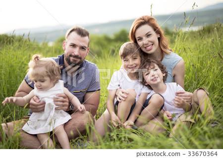 Happy family in the meadow 33670364