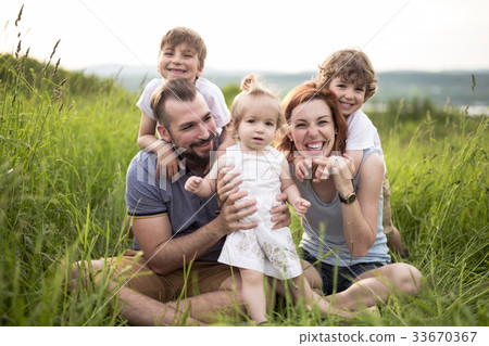 Happy family in the meadow 33670367