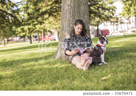 woman with terrier dog outside at the park woman with terrier dog outside at the park 33670471