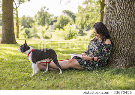 woman with terrier dog outside at the park 33670496
