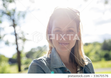Young woman with long blond hair posing outside Young woman with long blond hair posing outside 33670576