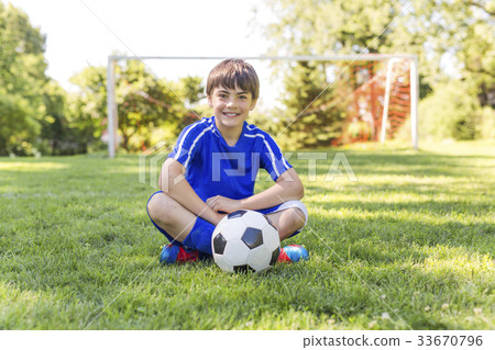 Young boy with soccer ball on a sport uniform Young boy with soccer ball on a sport uniform 33670796