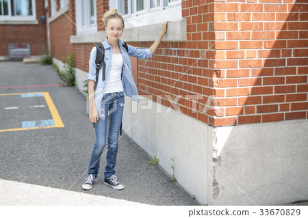 Nice Pre-teen boy outside at school having good Nice Pre-teen boy outside at school having good 33670829