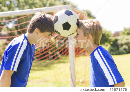 Two Young boy with soccer ball on a sport uniform Two Young boy with soccer ball on a sport uniform 33671276