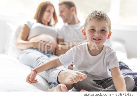 father, son and pregnant mother at home. Beautiful 33671453