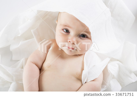 Toddler ripping up toilet paper in bathroom studio 33671751