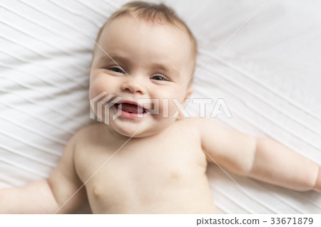 Cute happy 7 month baby girl in diaper lying and Cute happy 7 month baby girl in diaper lying and 33671879