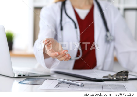 Female medicine doctor offering helping hand in 33673129