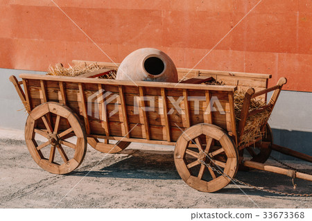 Wooden trolley with clay pitcher inside. Wooden trolley with clay pitcher inside. 33673368