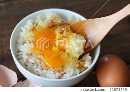 Brown raw egg with soy sauce and crumbled yolk 33673559