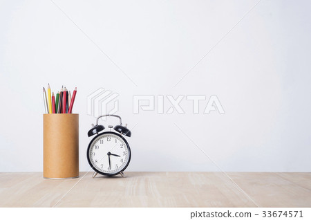 alarm clock and pencil on wood table alarm clock and pencil on wood table 33674571