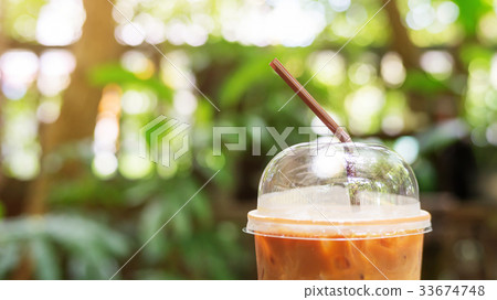 Close up of a straw in iced latte coffee. 33674748