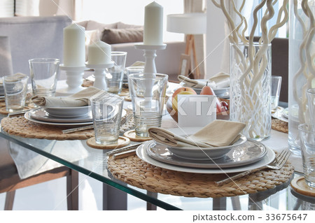 elegant table set in modern style dining room 33675647