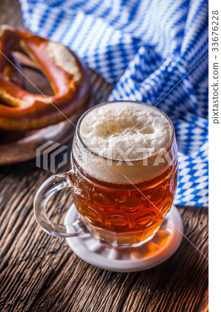 Draft beer pretzel and blue checkered tablecloth. Draft beer pretzel and blue checkered tablecloth. 33676228