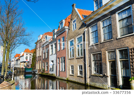 houses and canal in Delft, Holland at sunset 33677356
