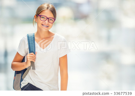 Portrait of happy teen school girl with backpack. Portrait of happy teen school girl with backpack. 33677539