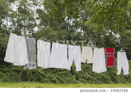 Old-fashioned clothesline with clothing. 33682580