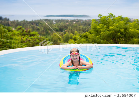 Child with goggles in swimming pool. Kids swim. Child with goggles in swimming pool. Kids swim. 33684007