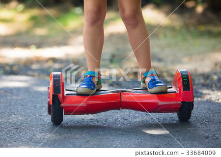 Child on hover board. Kids ride scooter. 33684009