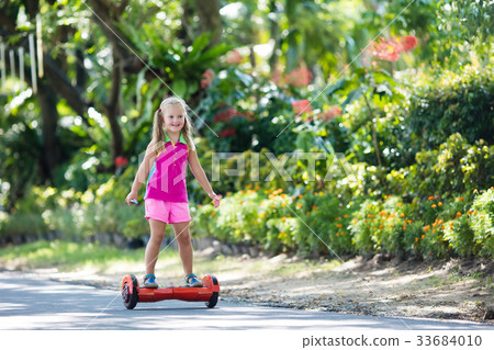 Child on hover board. Kids ride scooter. 33684010
