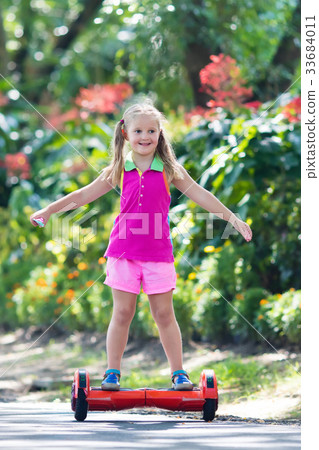 Child on hover board. Kids ride scooter. Child on hover board. Kids ride scooter. 33684011