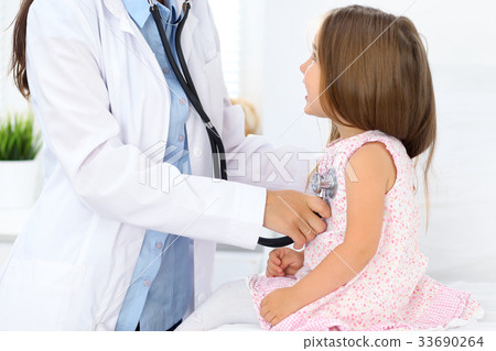 Doctor examining a little girl by stethoscope Doctor examining a little girl by stethoscope 33690264