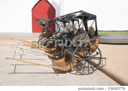 Many old carts parked on the street. 33690779