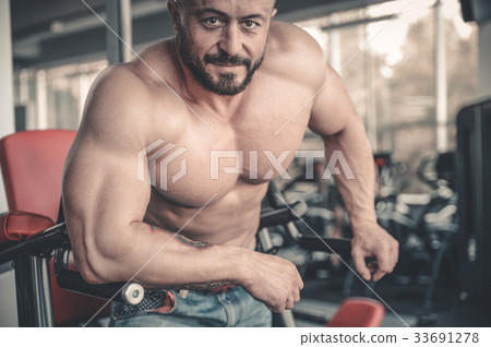 Handsome athletic man on diet training muscles Handsome athletic man on diet training muscles 33691278