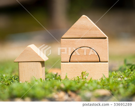 Big wooden home and small wooden home on grass. 33691289