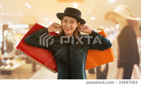 Woman with shopping bag in shopping mall Woman with shopping bag in shopping mall 33697003