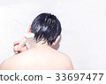 A man washing his head 33697477