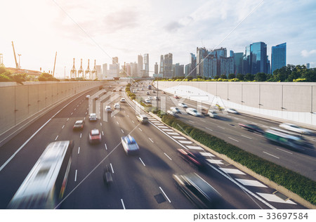 Busy road and city background during rush hour Busy road and city background during rush hour 33697584