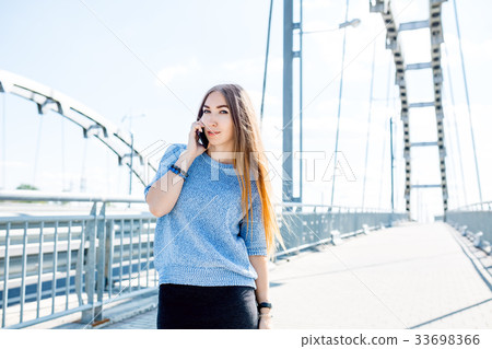 Beautiful happy young businesswoman using cell 33698366