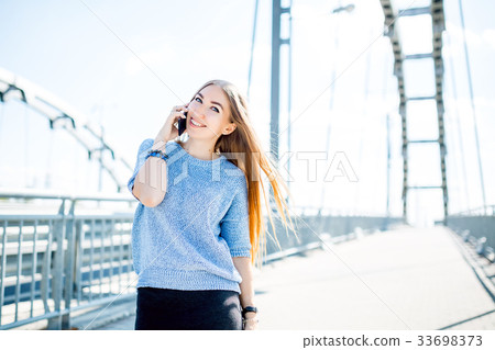 Beautiful happy young businesswoman using cell Beautiful happy young businesswoman using cell 33698373