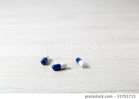 Three blue medicine capsules Three blue medicine capsules 33701715