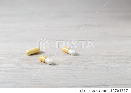 Three yellow medicine capsules Three yellow medicine capsules 33701717