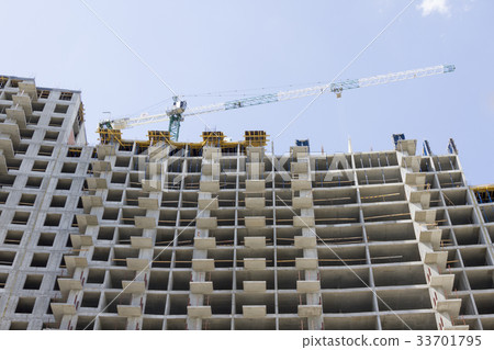 Crane and building construction on sky background Crane and building construction on sky background 33701795