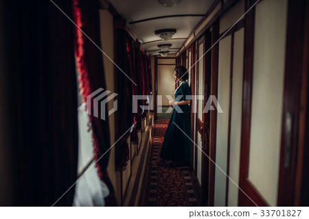 Young woman travels, vintage train compartment 33701827