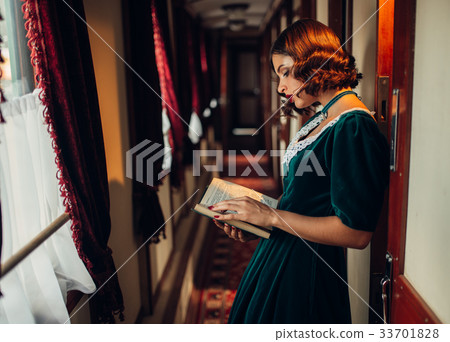 Young woman travels, vintage train compartment 33701828
