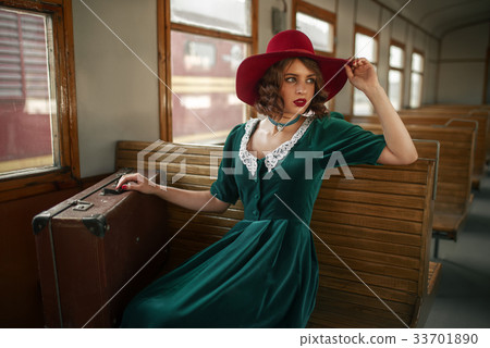 Beautiful woman in retro train, old wagon interior 33701890