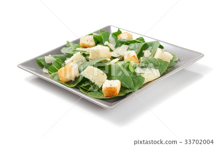 caesar salad in plate on white background 33702004