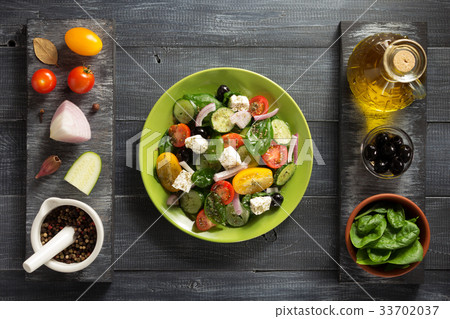 fresh greek salad in plate and ingredients 33702037
