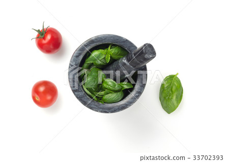 basil in mortar on white background 33702393